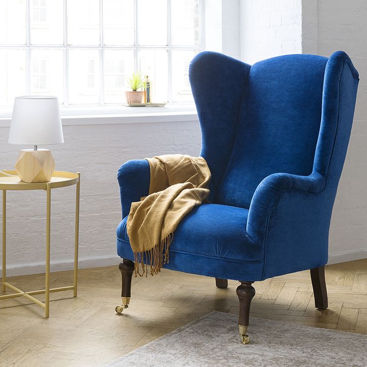 Blue velvet wing backed armchair