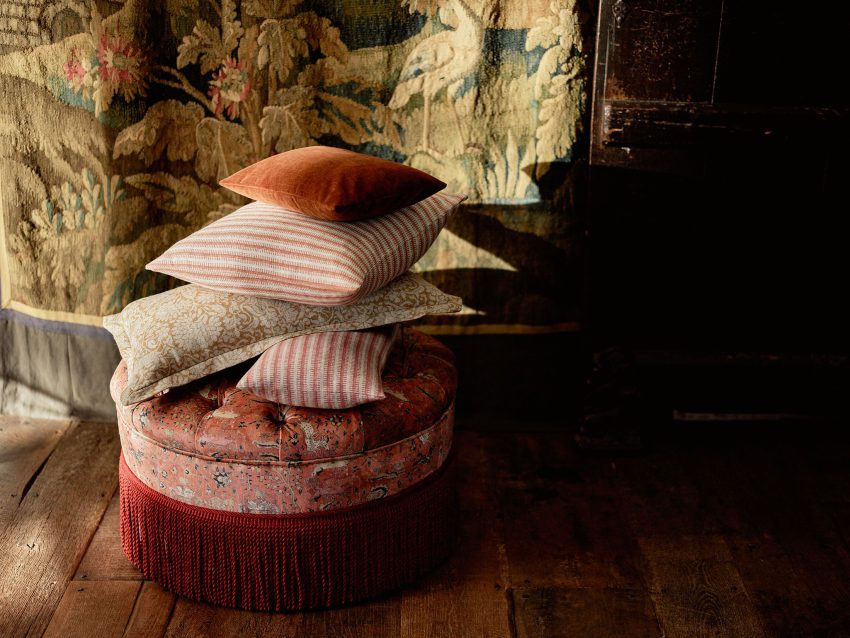 Cushions piled up on a footstool.