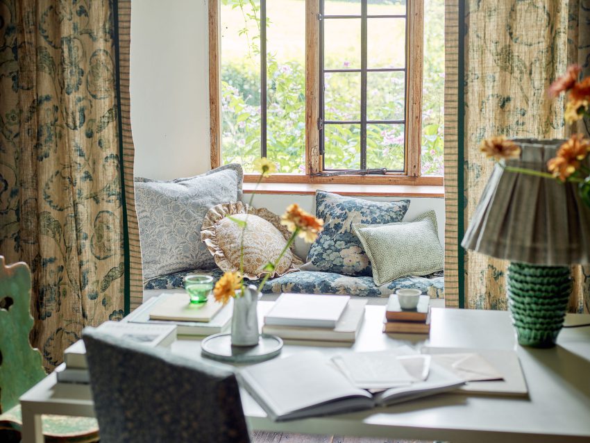 A window seat covered in patterned cushions.